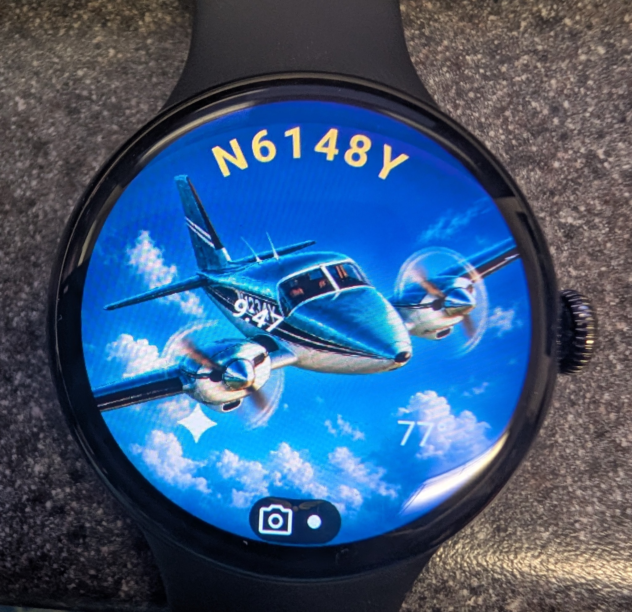 A personalized aviation watch face with a twin-engine airplane and N6148Y